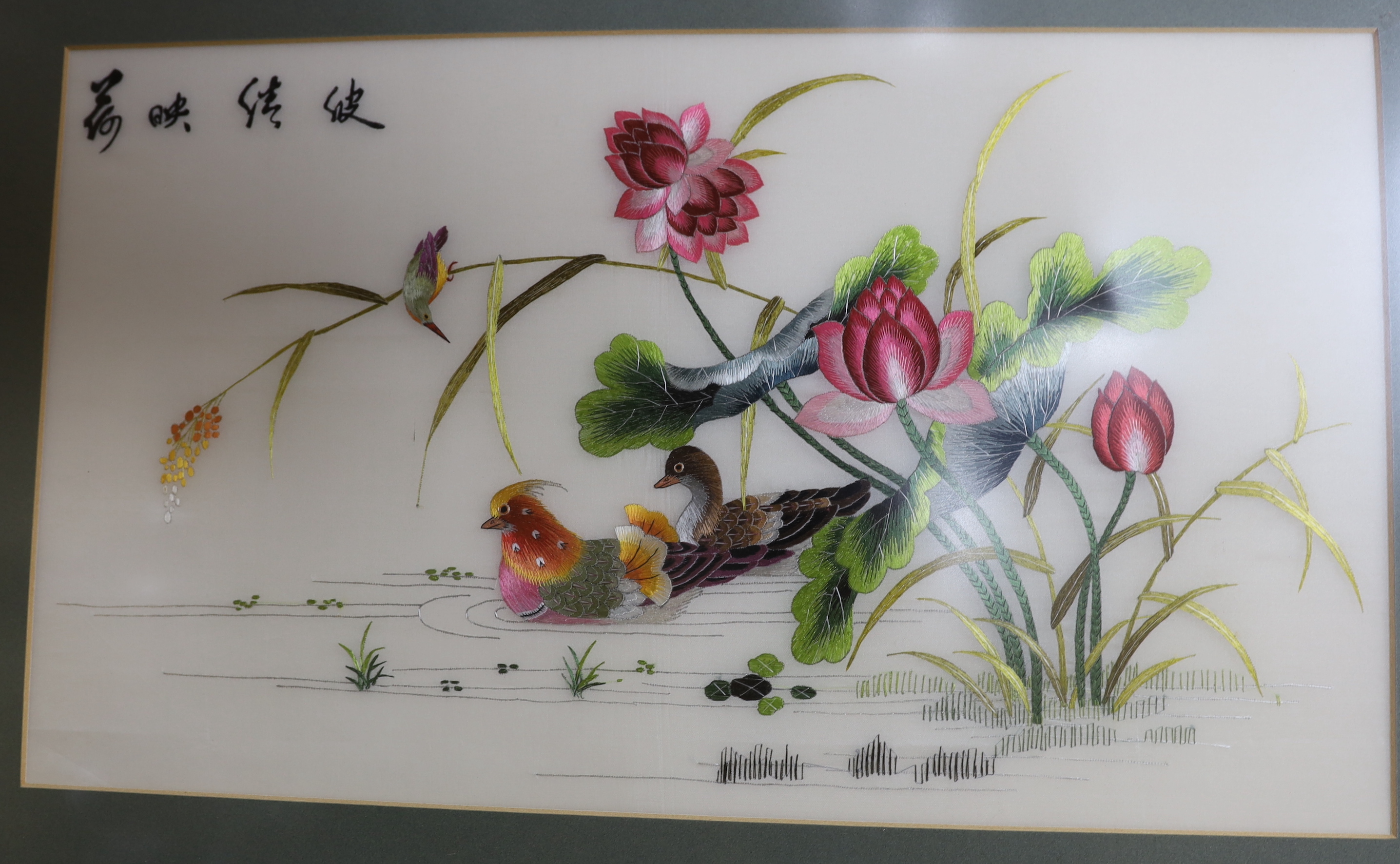 Four Chinese silk embroidered pictures including birds of paradise and a calligraphy scroll (each framed), largest 62cm x 36
